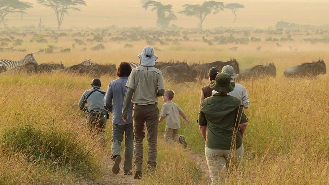 Family walking safari Serengeti Tanzania